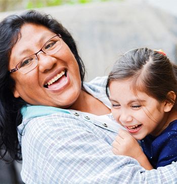 a woman holding a young girl in her arms